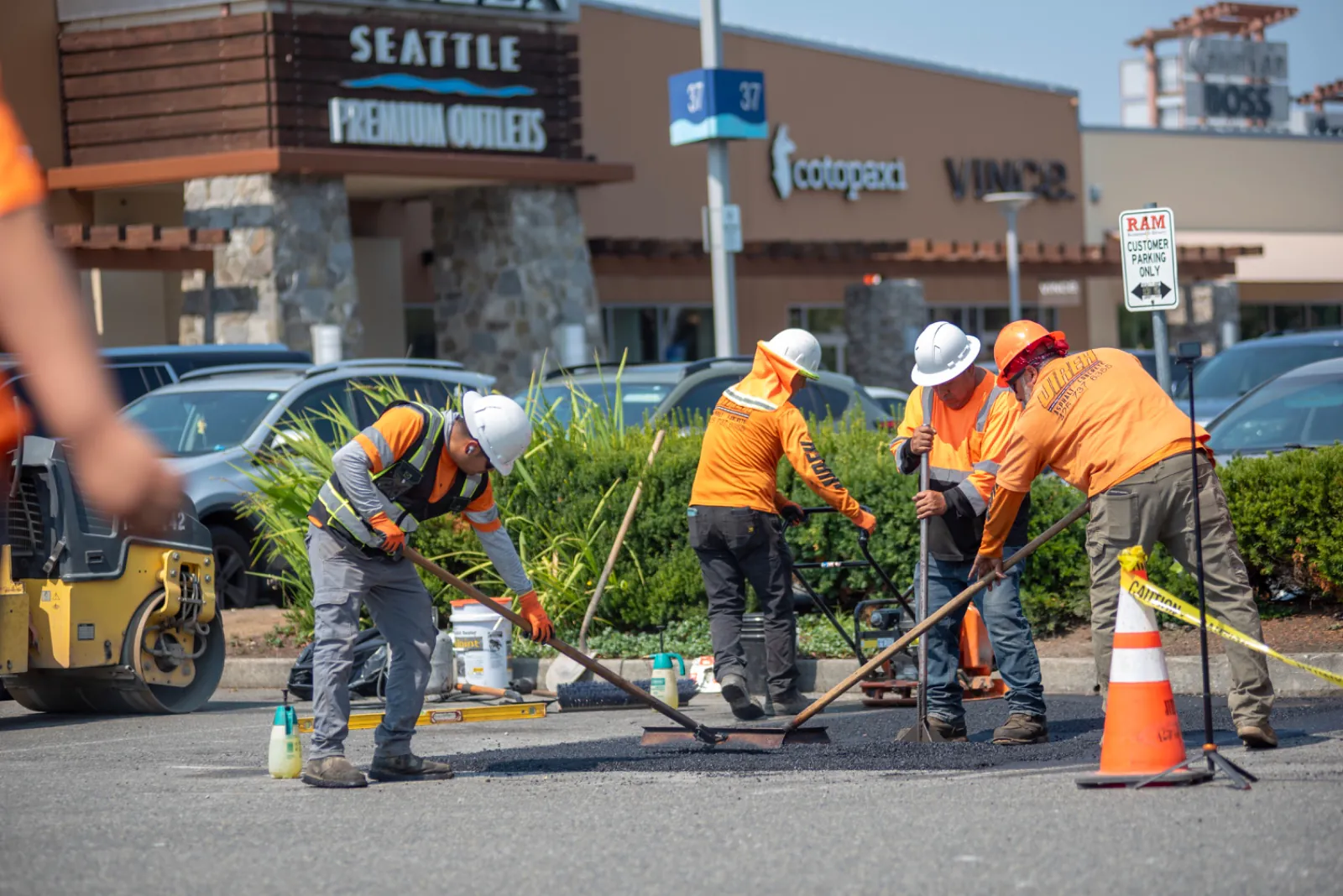 Jireh crew members coordinating asphalt surface work at an active commercial property.