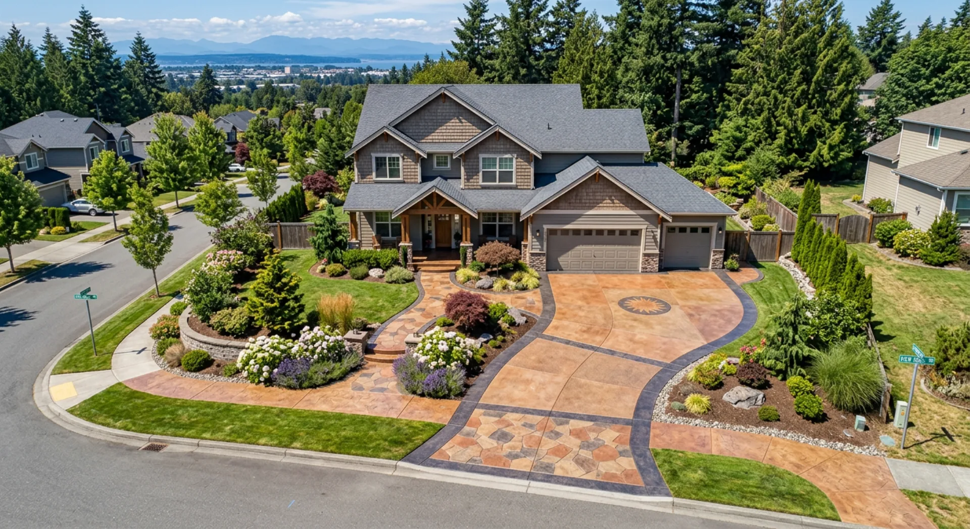 Colored concrete driveway and walkway system with warm earth tones at a residential property