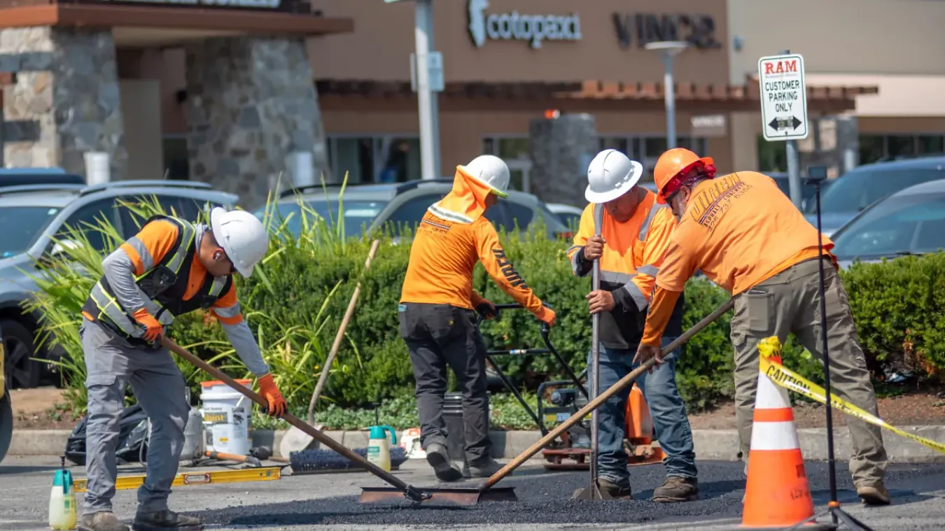 Jireh crew members coordinating asphalt surface work at an active commercial property